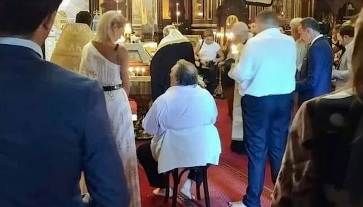 Gerard Depardieu (sitting) during the Sacrament of Baptism. Photo: twitter.com/dimsmirnov175
