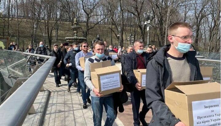 Credincioșii Bisericii Ortodoxe Ucrainene duc cutiile cu semnături sub apelul adresat lui Zelenski. Imagine: UJO