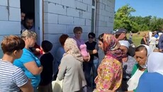 In Kononivka, priest have to give communion to believers through a window