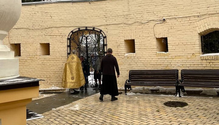 Worshippers in the Lavra continue to receive communion through the bars