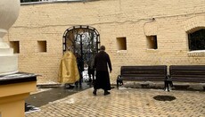 Worshippers in the Lavra continue to receive communion through the bars