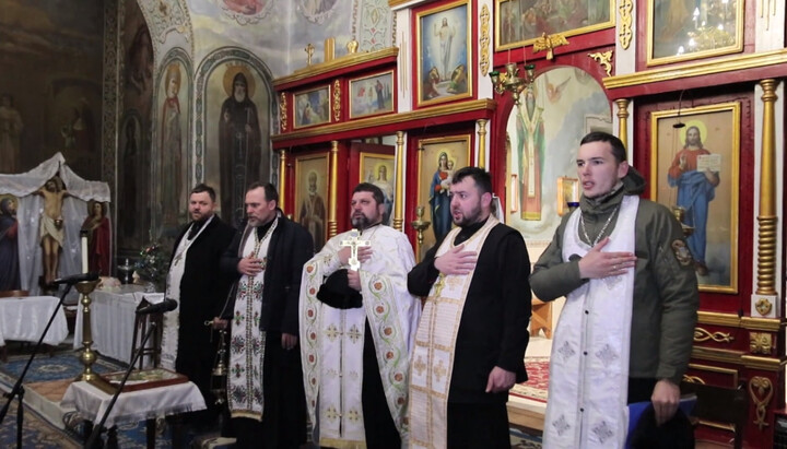 Clericii BOaU cântă imnul național ucrainean pe solea bisericii acaparare din Ladyjin. Imagine: screnshot de pe canalul de YouTube 